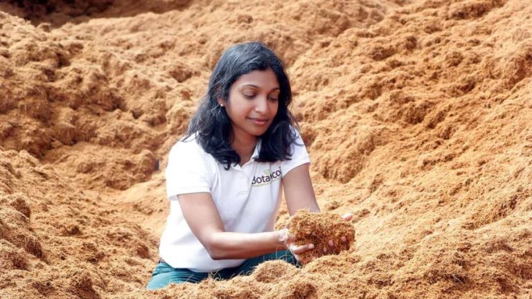 Botanicoir employee Samantha holding coir at a production facility