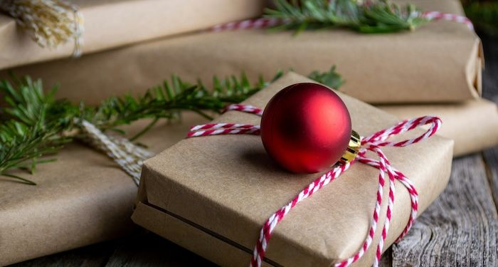 gifts wrapped in brown paper with red ornaments.jpg.optimal