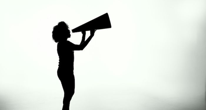person shouting into megaphone.jpg.optimal